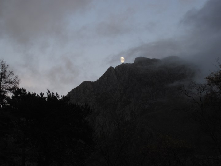 The Moon over the west face of Tryfan in Snowdonia National Park, Wales.
