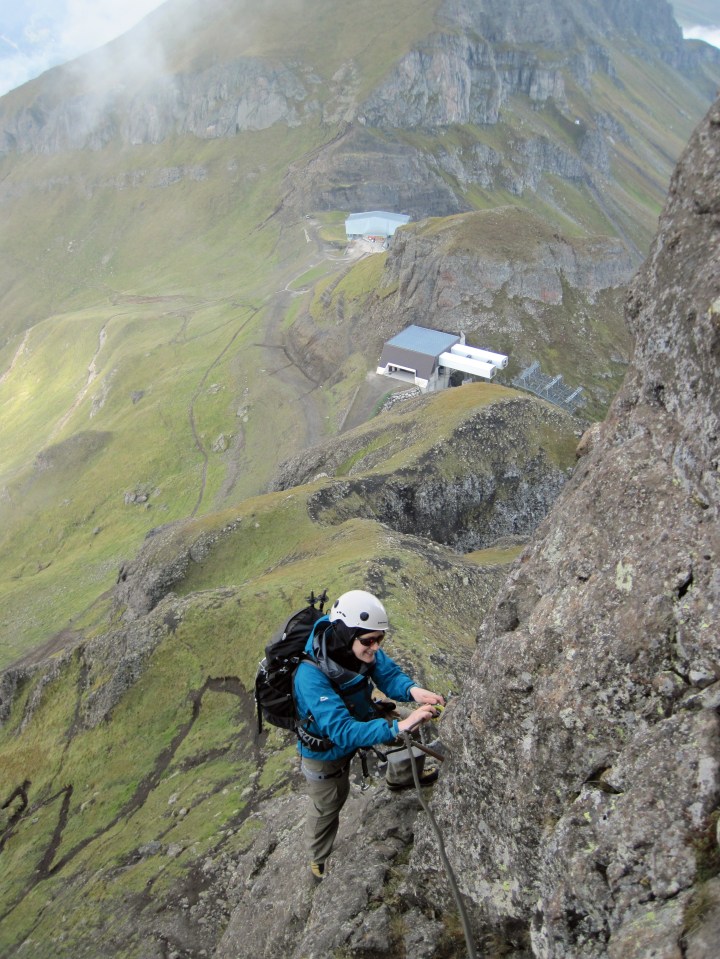 Climbing the via ferrata Via Delle Trincee in the Dolomites.
