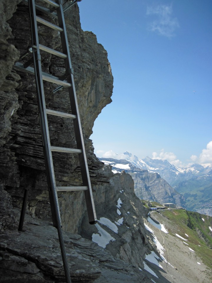 A ladder on the Rotstock Via Ferrata.  The Eigergletscher Station and Eiger Trail are behind and below.