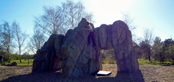 Valerie climbing on The Arches boulder at Fairlop Waters Boulder Park in London.
