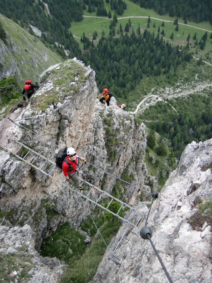 Valerie on the bridge on the Via Ferrata Sandro Pertini in the Dolomites, Italy.